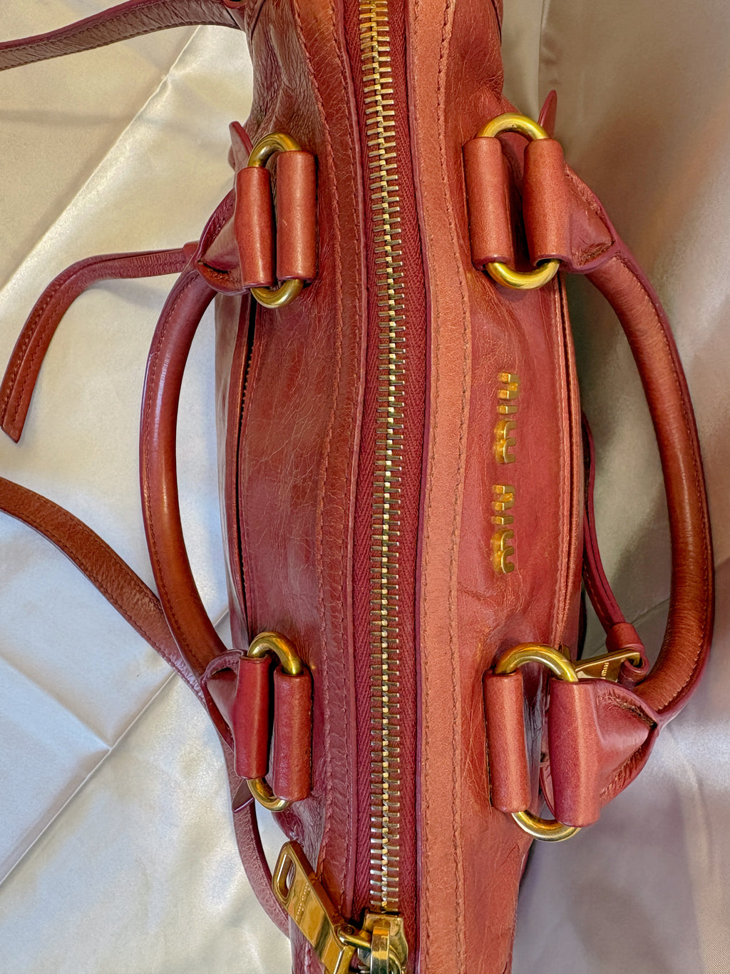 Miu Miu Vitello Lux Crossbody Bag – Red Distressed Leather Top-Handle Mini Bag with Gold Hardware